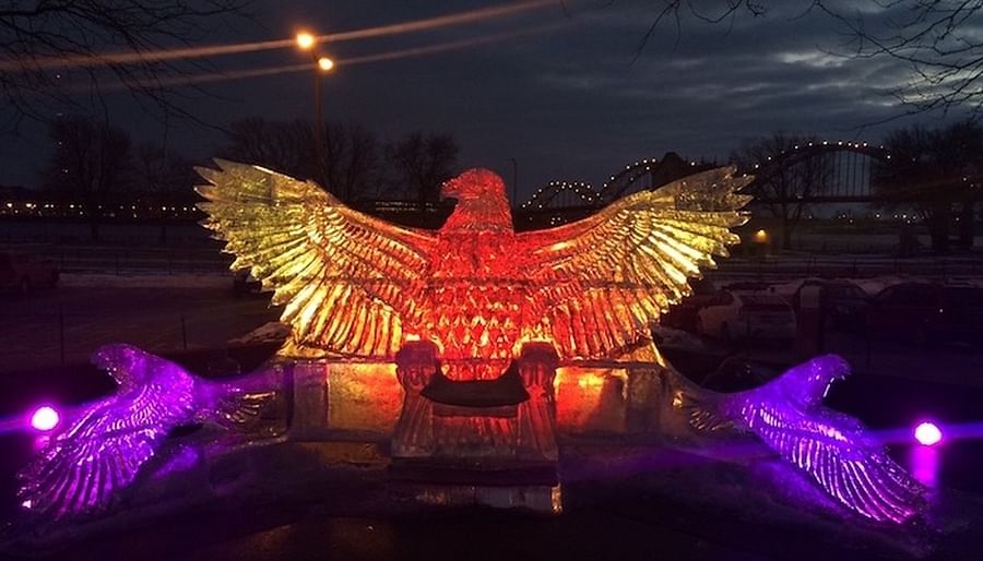 Majestic Swan Ice Sculpture Illuminated by Festival Lights