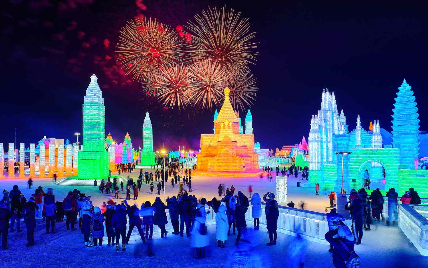 Illuminated ice sculptures at night during the Harbin Ice and Snow Festival