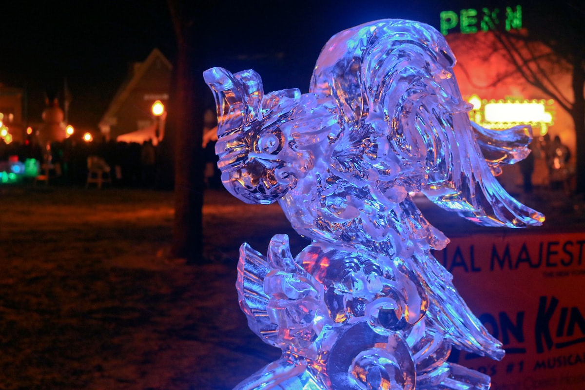 Illuminated ice sculpture at a competition captivating spectators